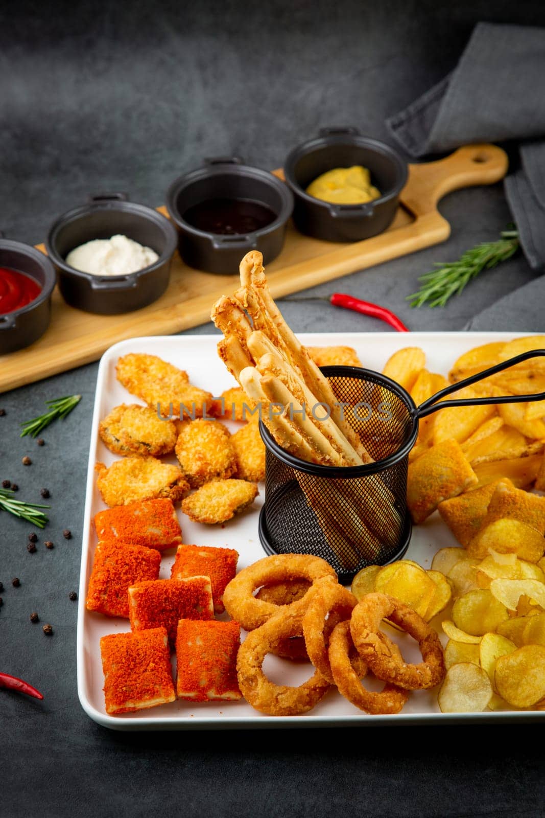 beer set with nuggets, breaded onion rings, fries and sauces