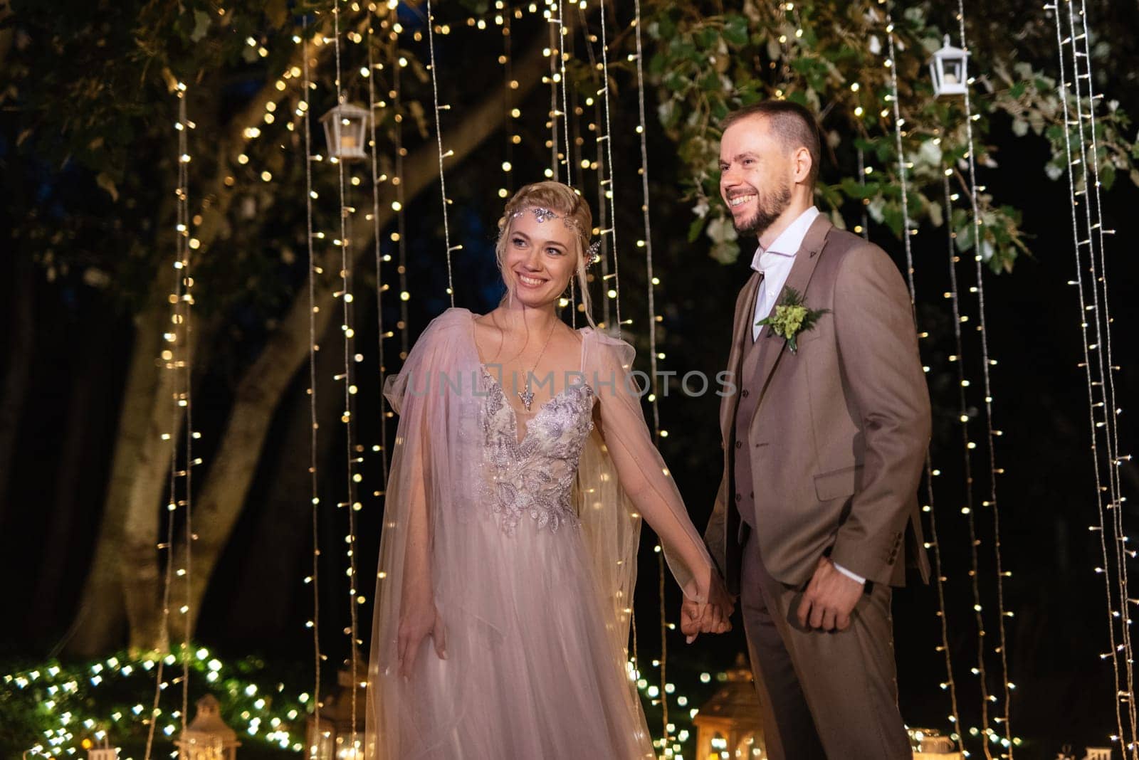 night wedding ceremony of the newlyweds in a country cottage on a green hill