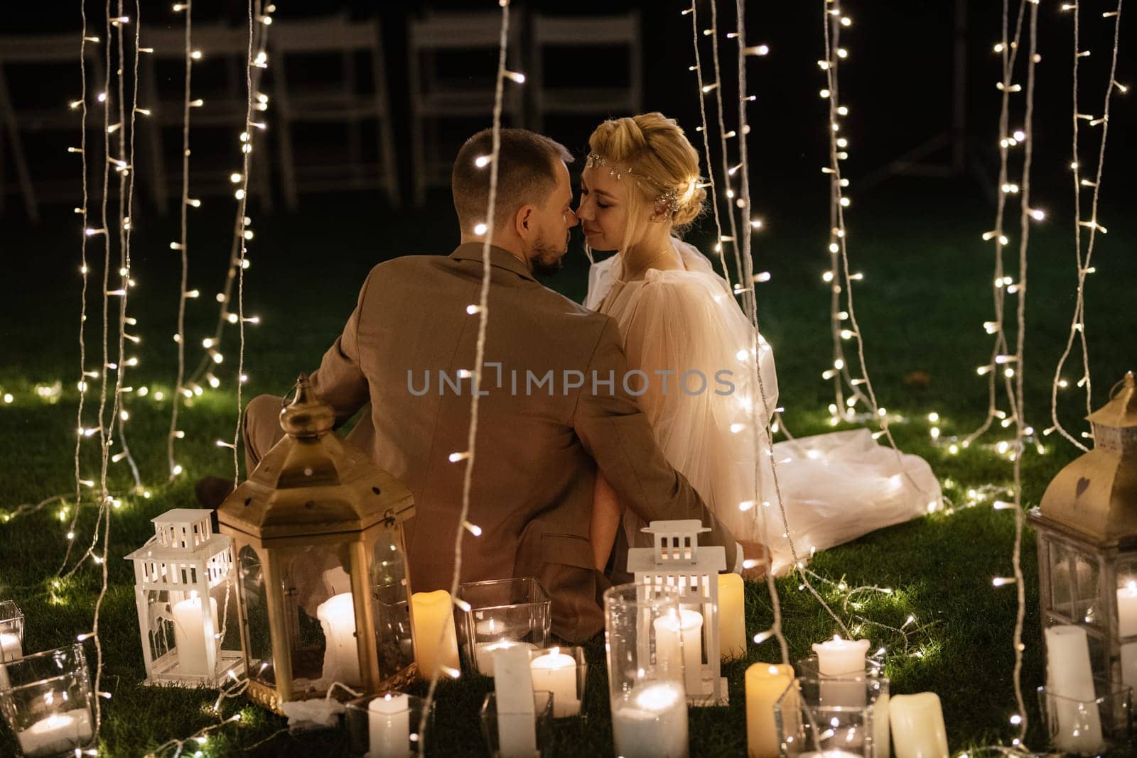 night wedding ceremony of the newlyweds in a country cottage on a green hill