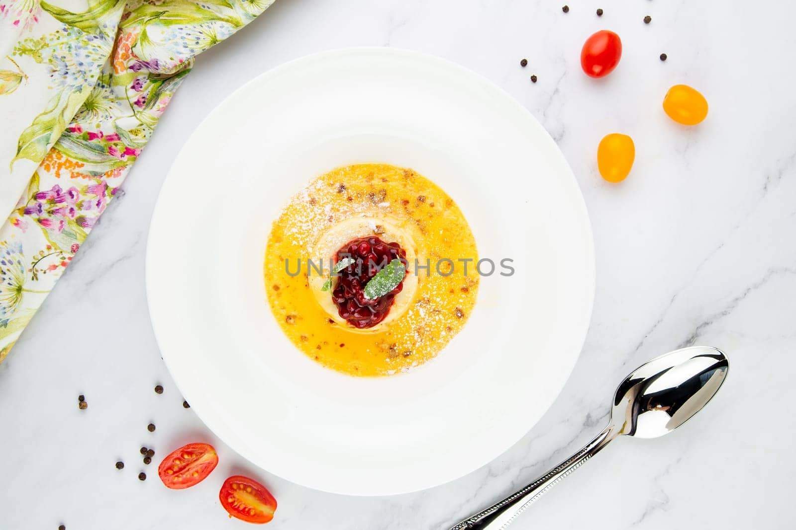 Ginger pumpkin soup with dumplings and berries. White background top view by tewolf