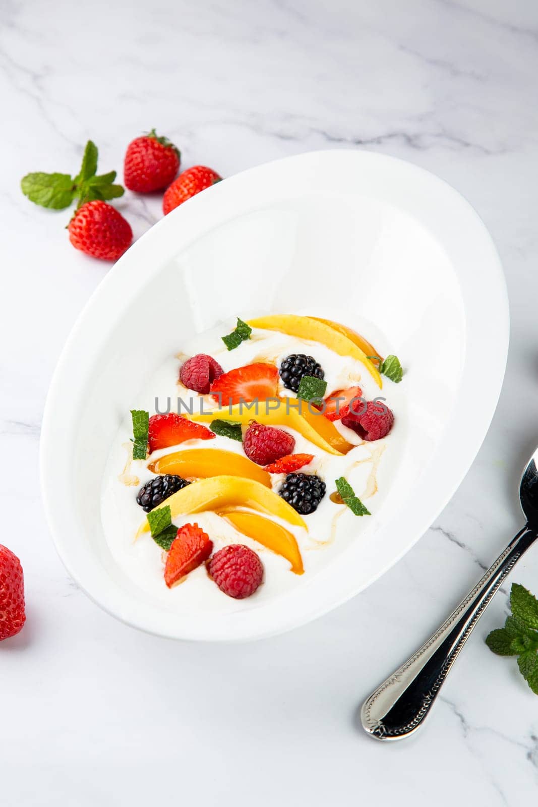 fruit salad with wild berries and strawberries side view by tewolf