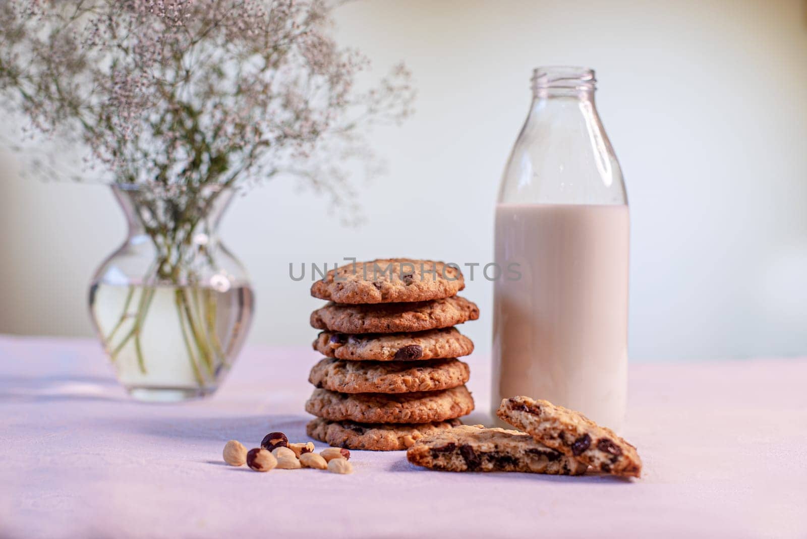 oatmeal cookies with hazelnuts and chocolate chips on the table by studiodav