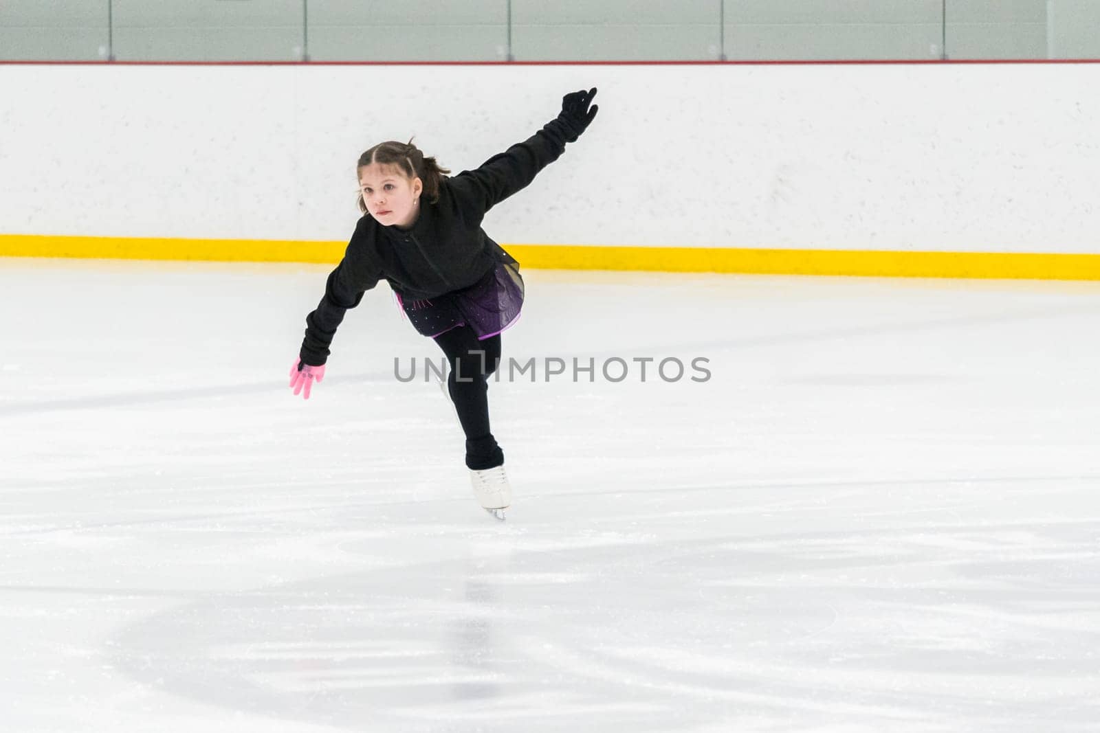 Figure skating practice at an indoor skating rink by arinahabich