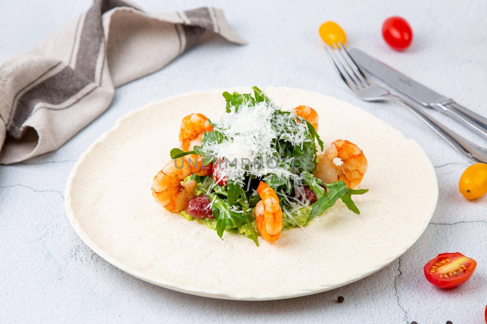 beautifully served shrimp with arugula and grated cheese