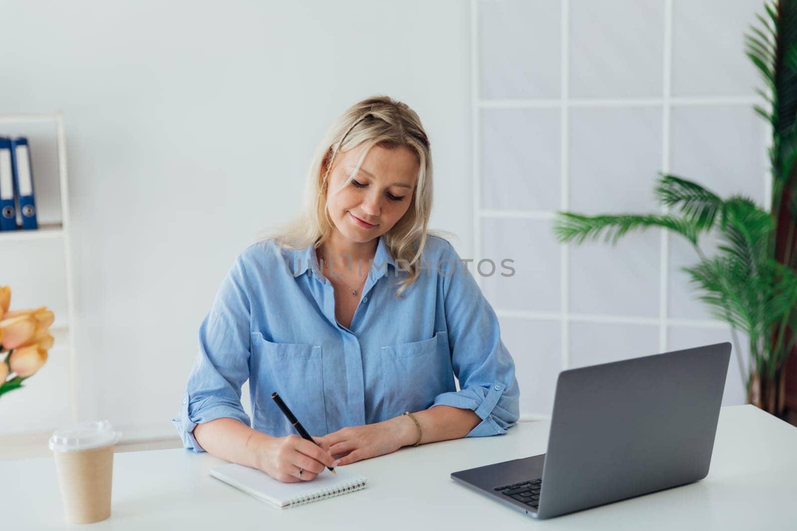 woman secretary working online at desk in office