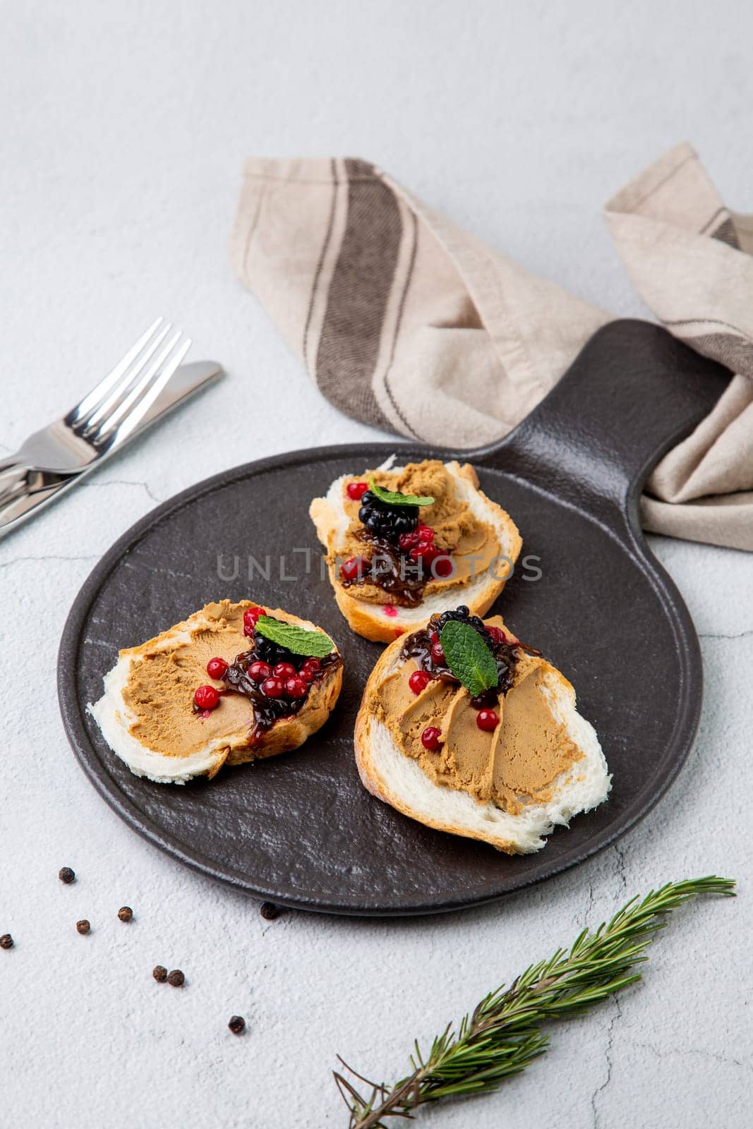 canapes with pate, mint leaves and berries, side view by tewolf