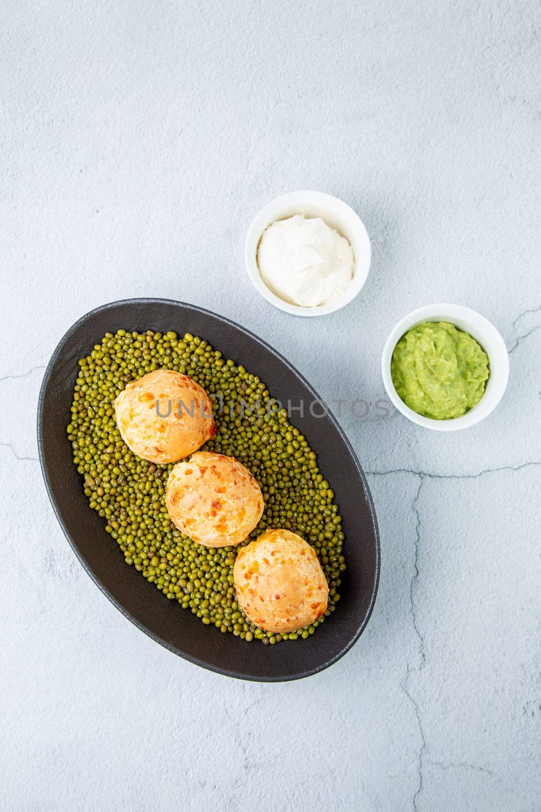 cooked meatballs on peas in an oblong bowl