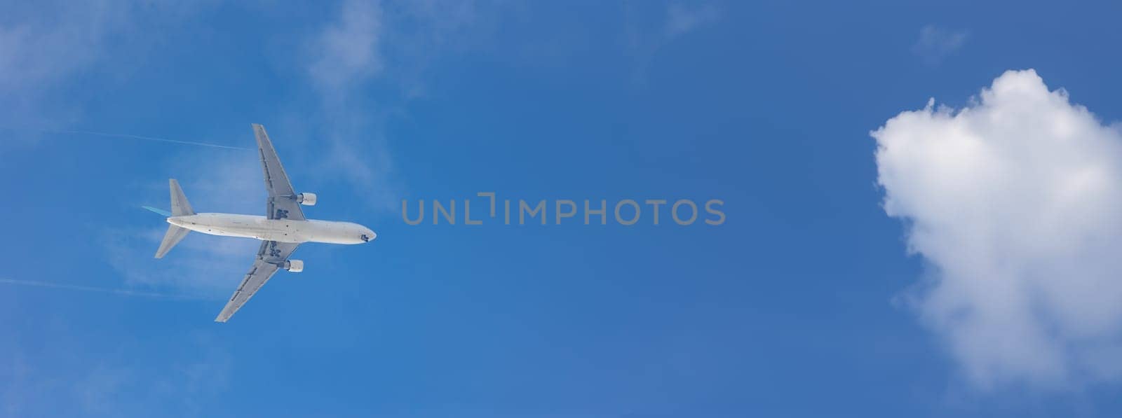 An Airplane Soaring Through the Vast Blue Sky by Studia72