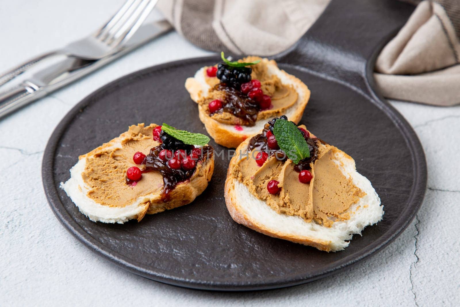 canapes with pate, mint leaves and berries