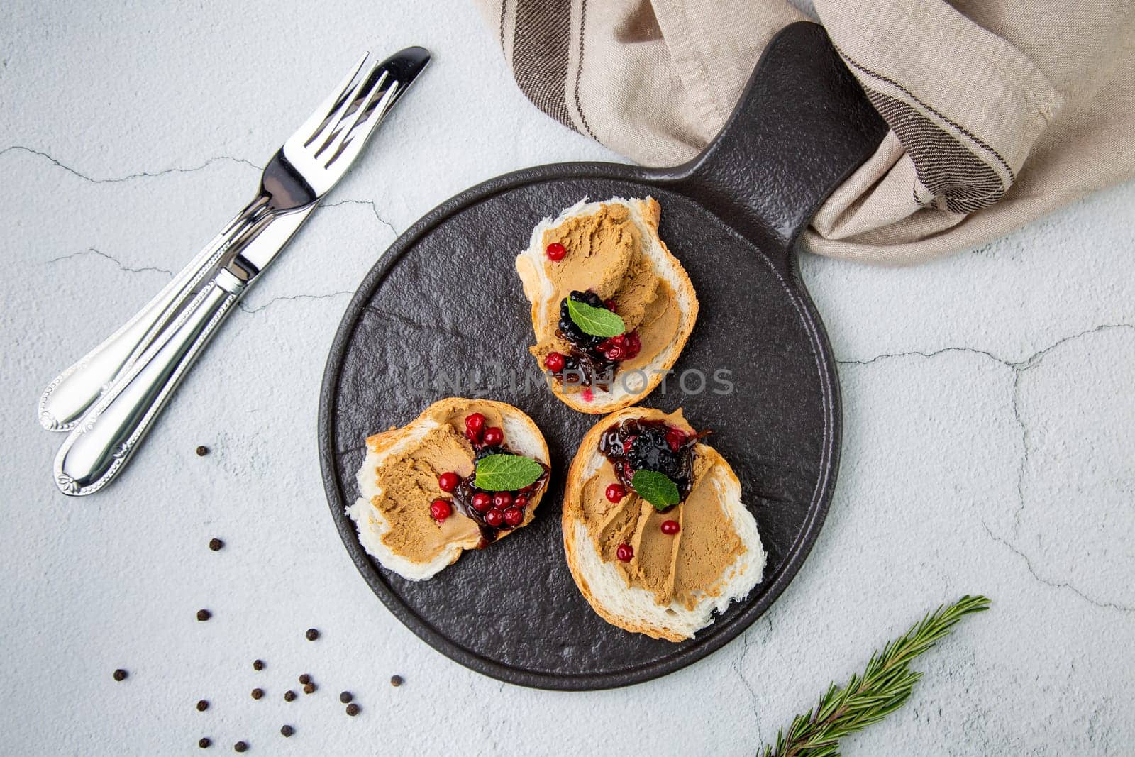 canapes with pate, mint leaves and berries, top view by tewolf