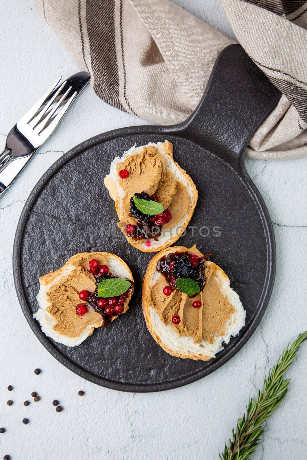 canapes with pate, mint leaves and berries, top view by tewolf