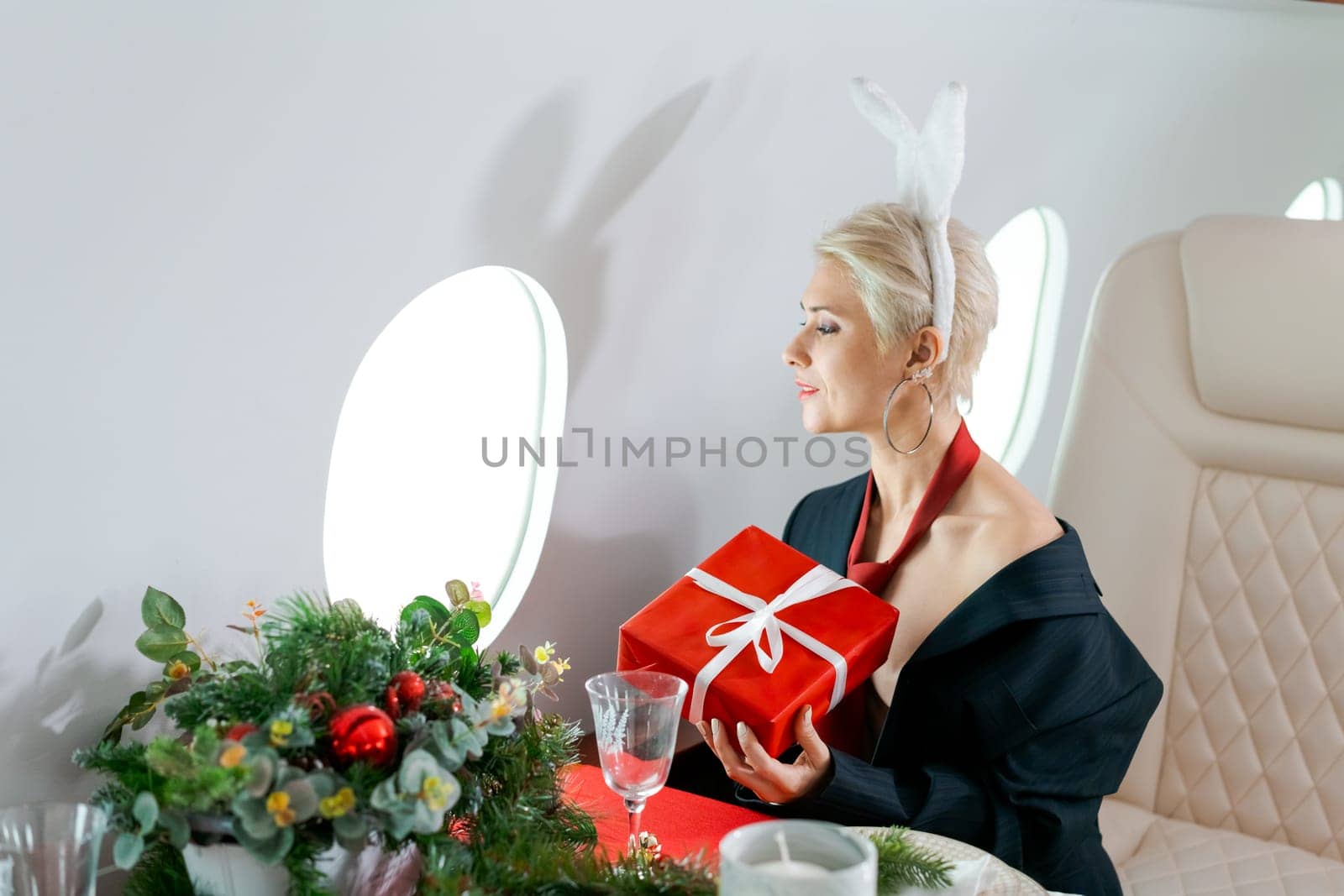 Woman private plane in a jacket with a red tie, New Year's Eve flight, holiday and travel concept by EkaterinaPereslavtseva