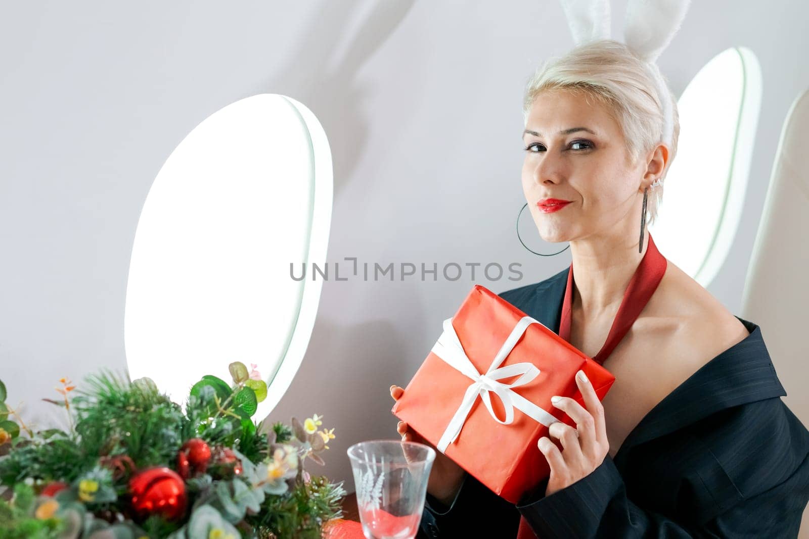 Woman private plane in a jacket with a red tie, New Year's Eve flight, holiday and travel concept