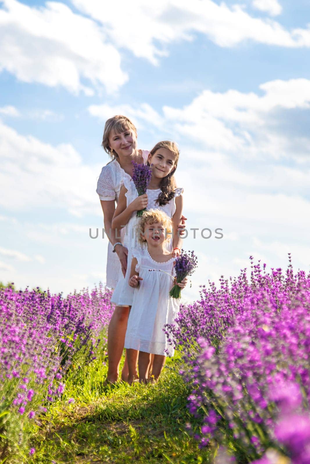Mother and children in a lavender field. Selective focus. by yanadjana