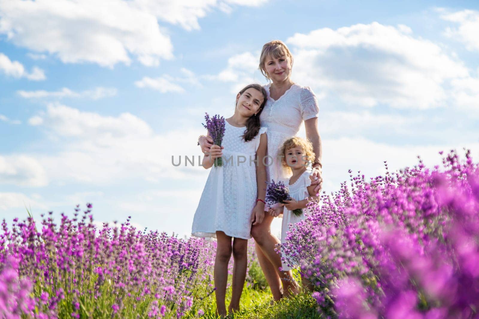 Mother and children in a lavender field. Selective focus. by yanadjana