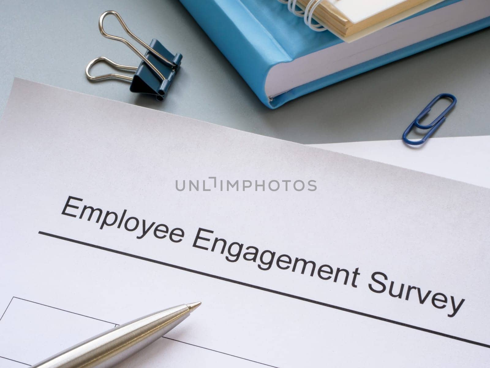 Employee engagement survey, notepads and a pen.