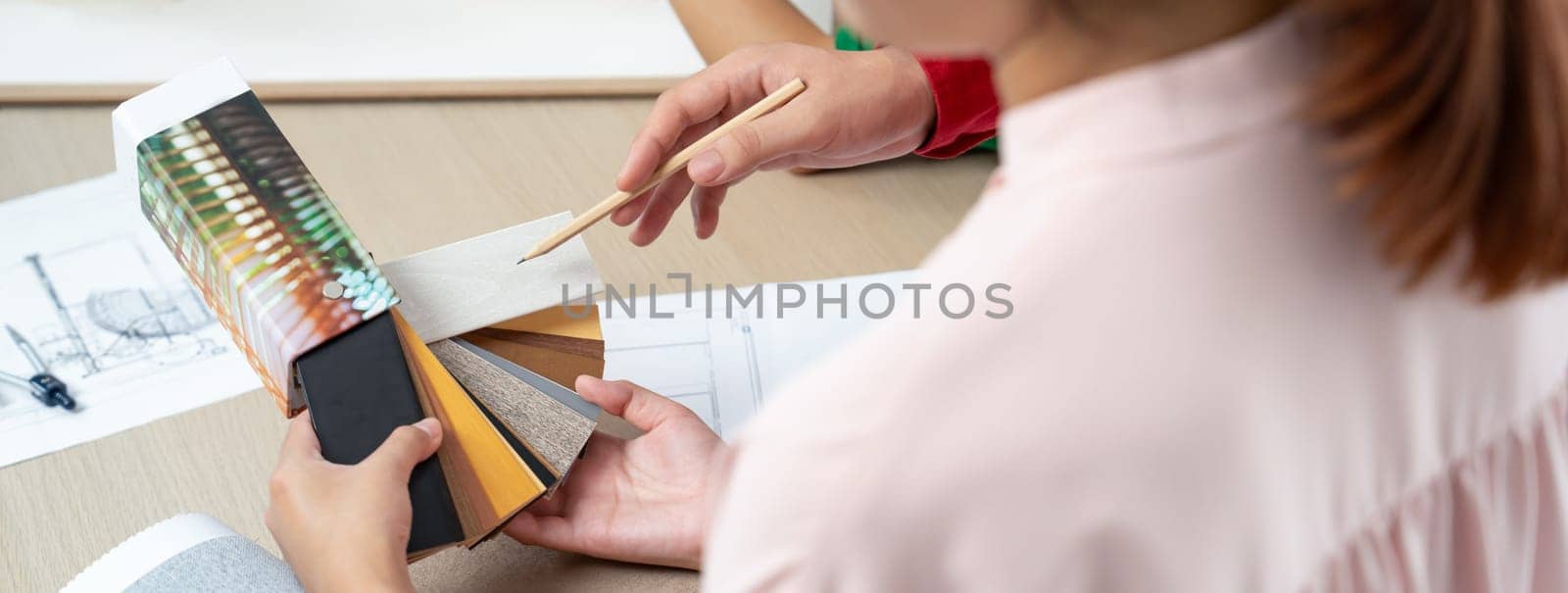 Cropped image of professional interior design team choose floor material from sample carefully. Skilled architect presented material sample to customer. Creative design concept. Variegated.