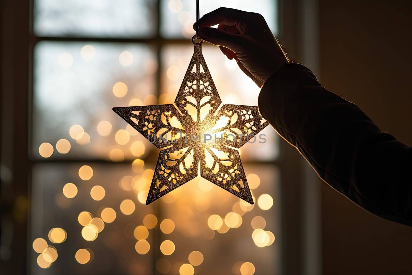 A person holding a star ornament in front of a window created with generative AI technology by golibtolibov