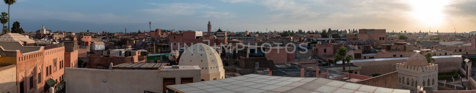 Panoramic view of the medina of Marrakech, the coupola of the Koubba Almoravid in the right side, seen from a rooftop, Morocco