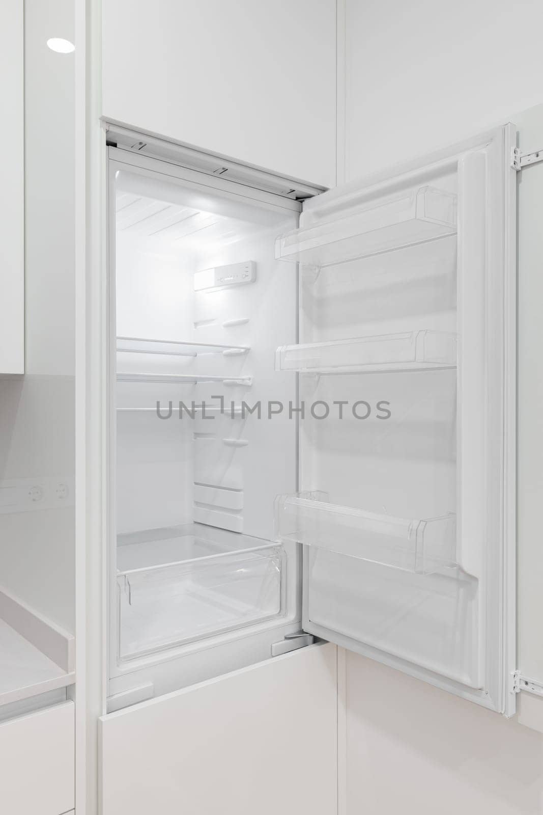 A white refrigerator with its door open in a kitchen