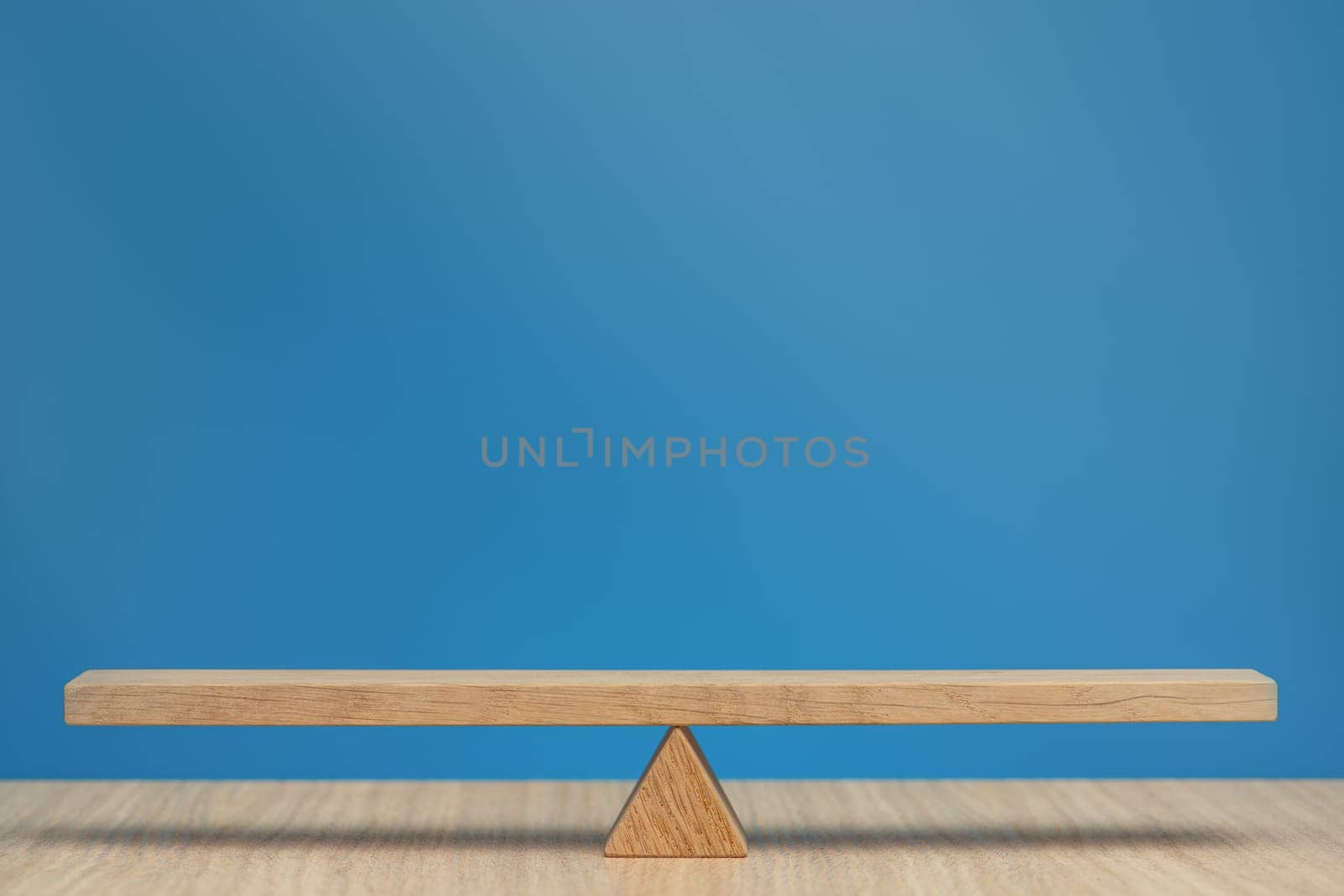 Empty wooden scales on a blue background. The concept of equilibrium and balance. High quality photo with copy space. High quality photo