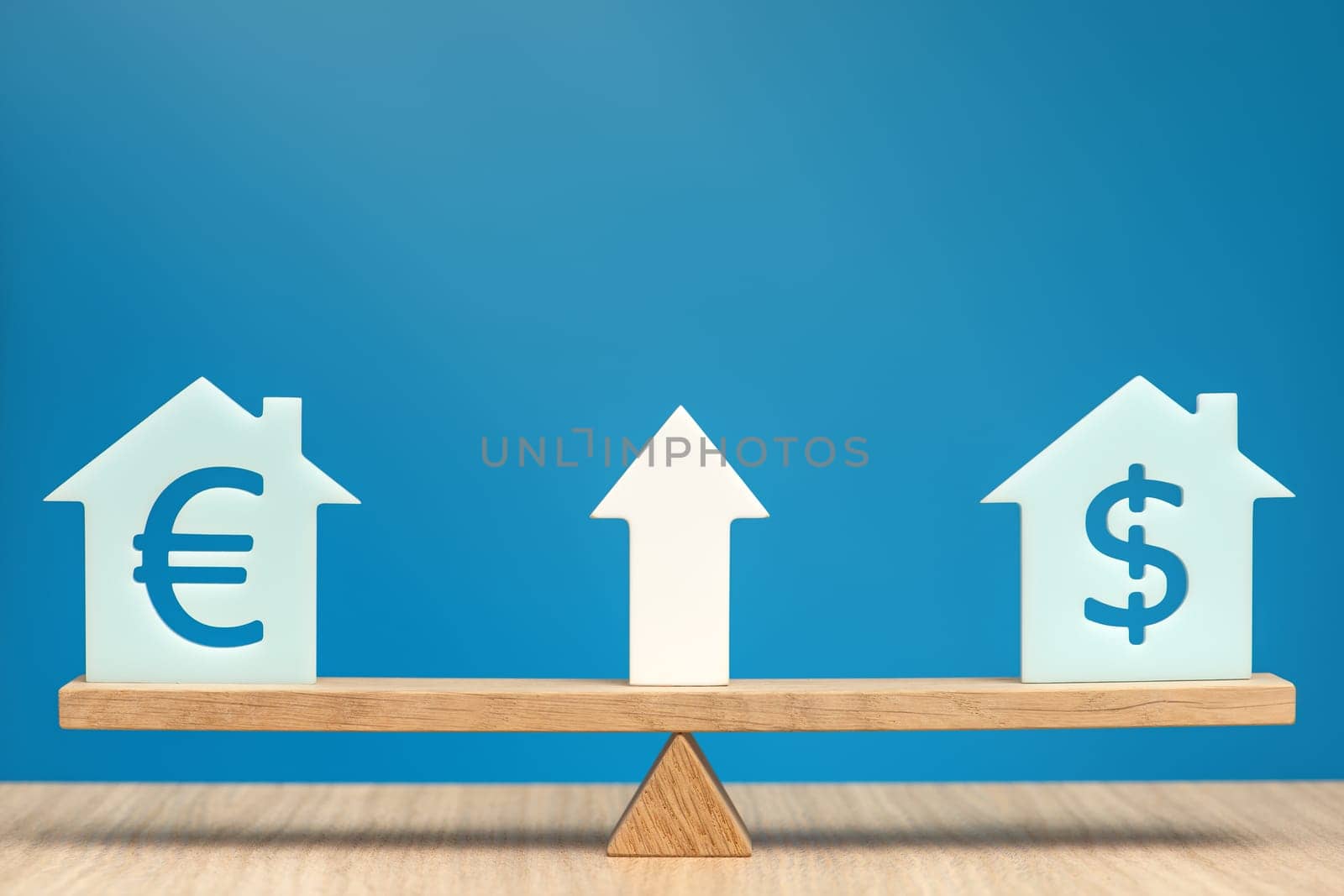Increasing the cost of housing. House models with dollar and euro symbols balance on the scales. Banner on the theme of real estate discounts on a blue background and a white arrow pointing up