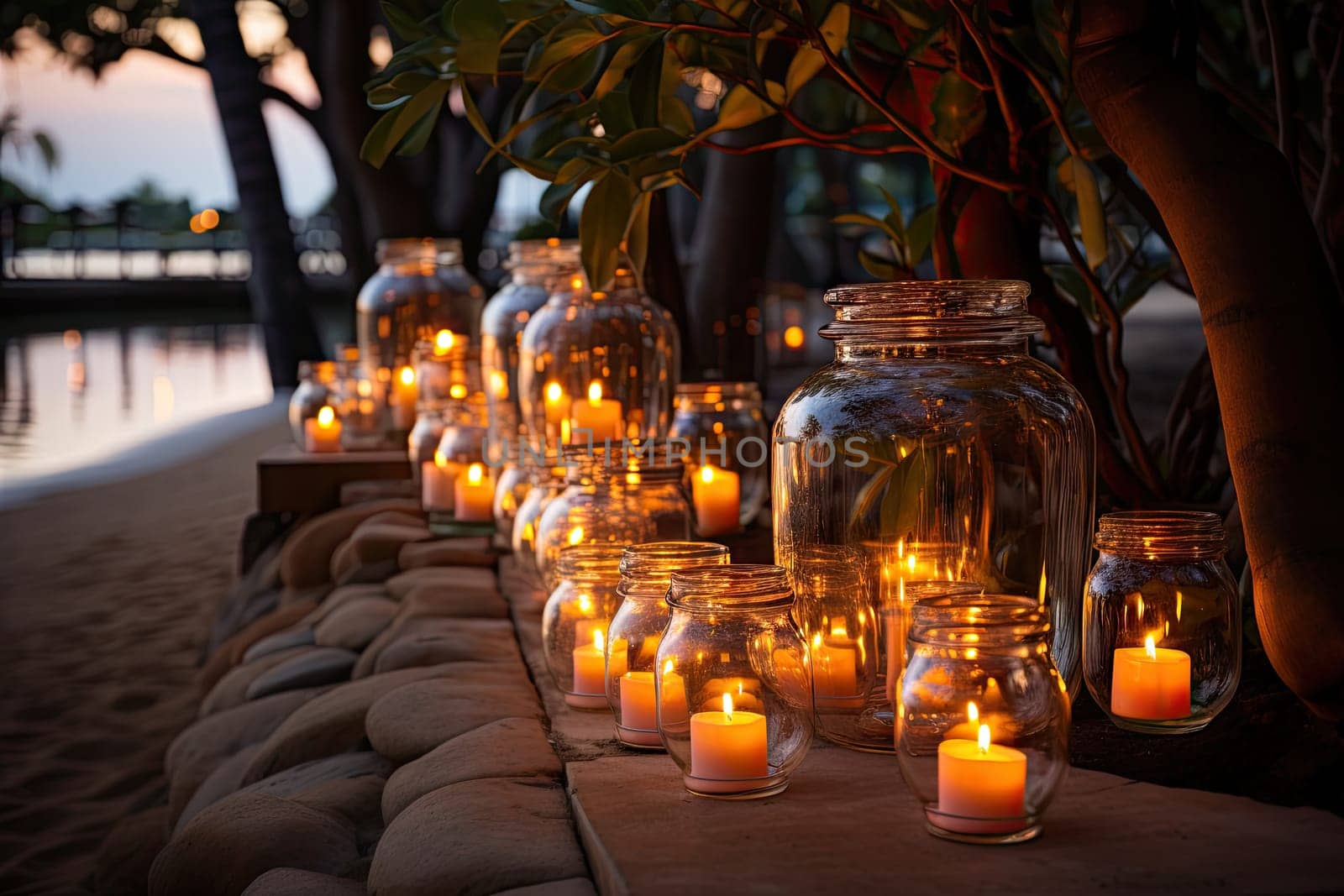 A row of glass jars filled with lit candles by golibtolibov