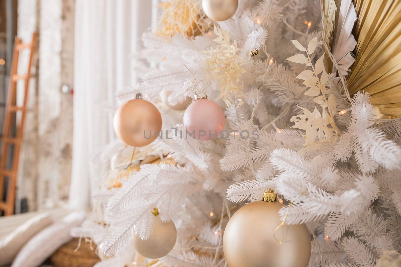 White Christmas decoration with balls on fir branches with blurred background