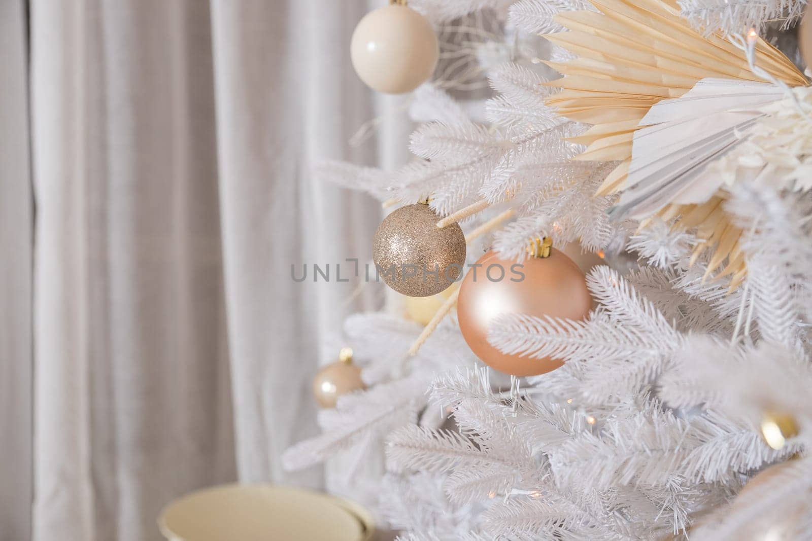 White Christmas decoration with balls on fir branches with blurred background