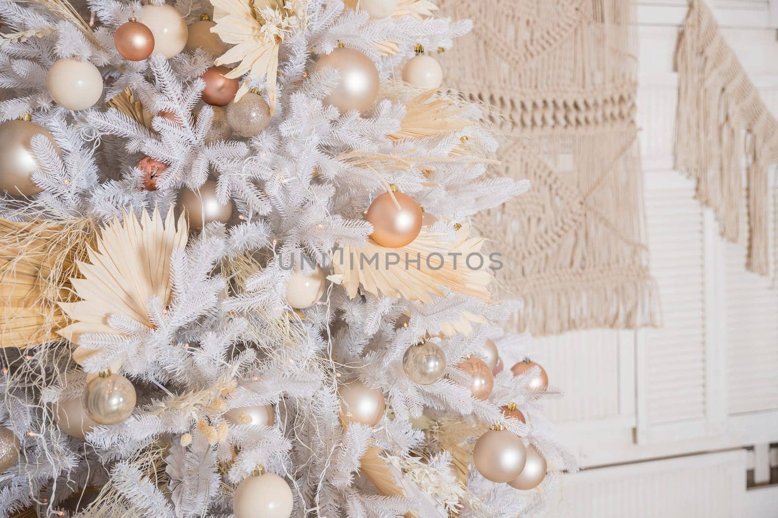 White Christmas decoration with balls on fir branches with blurred background