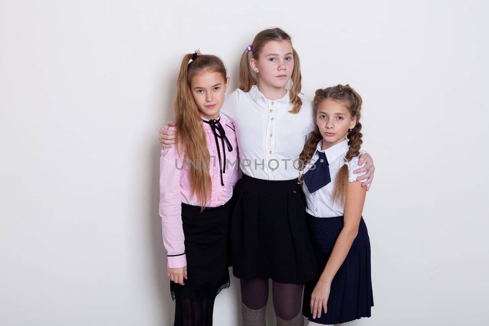 three schoolgirls in class at the school board by Simakov