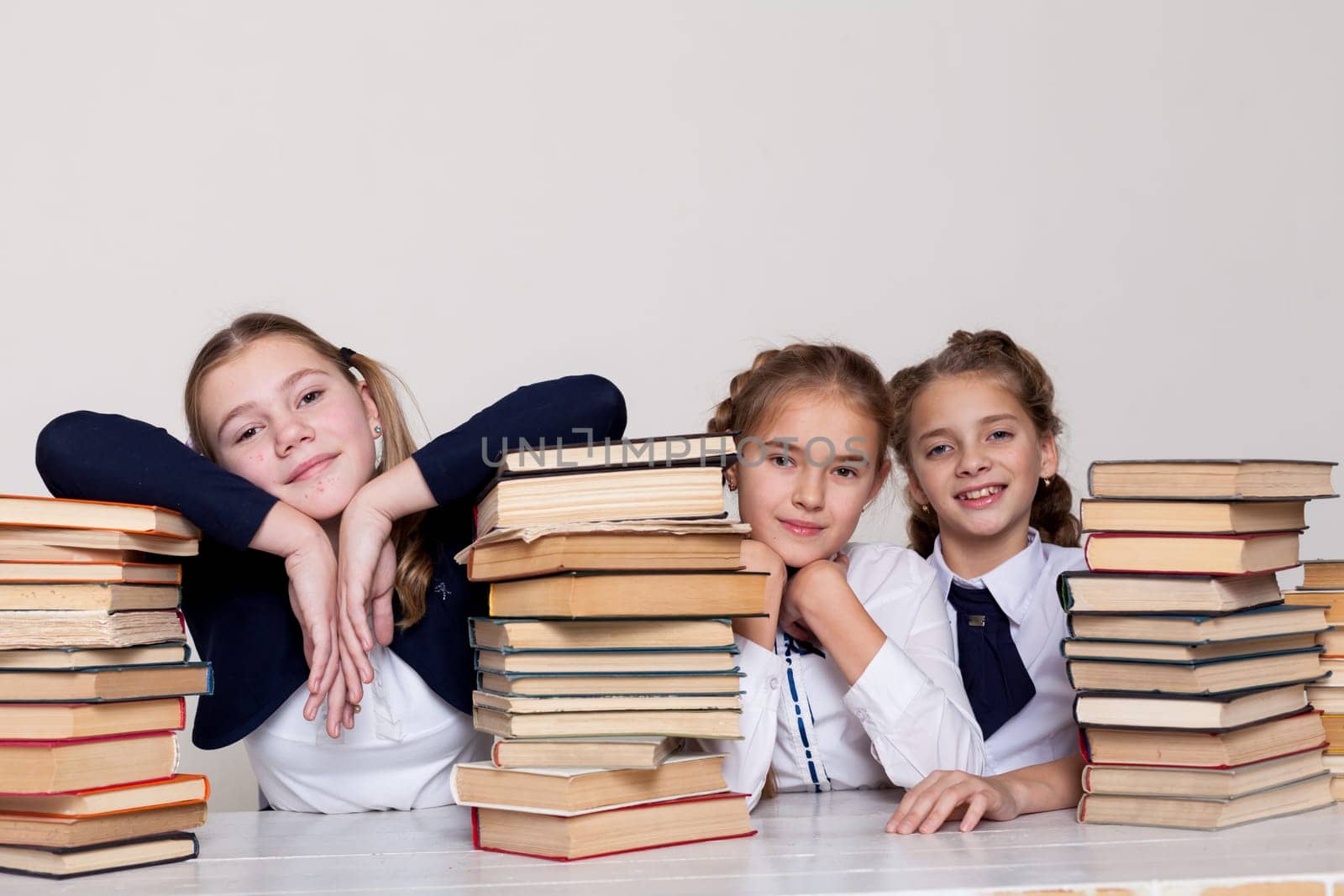 three girls in class at school with books