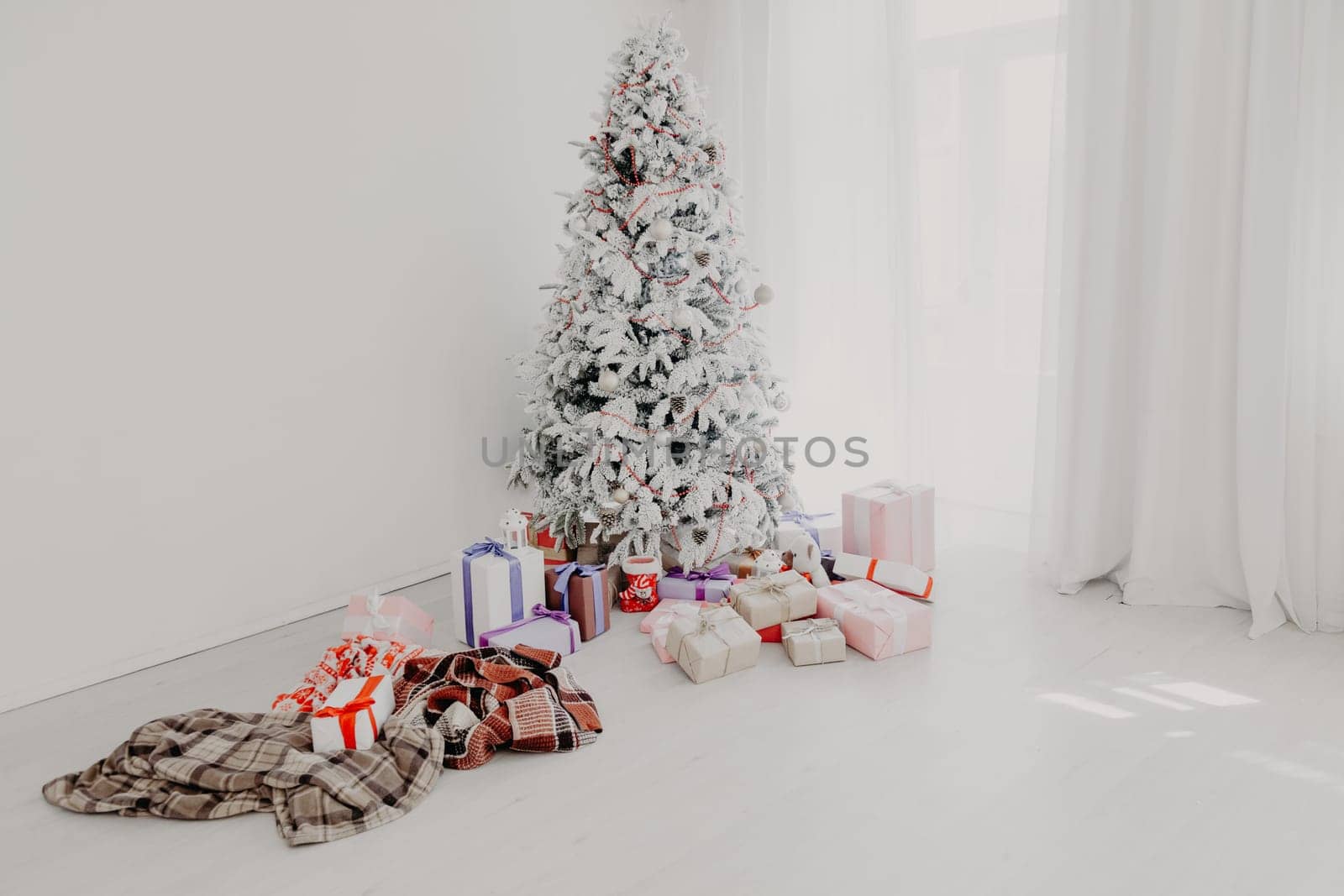 the Interior of the white room with a Christmas tree and Christmas gifts 8