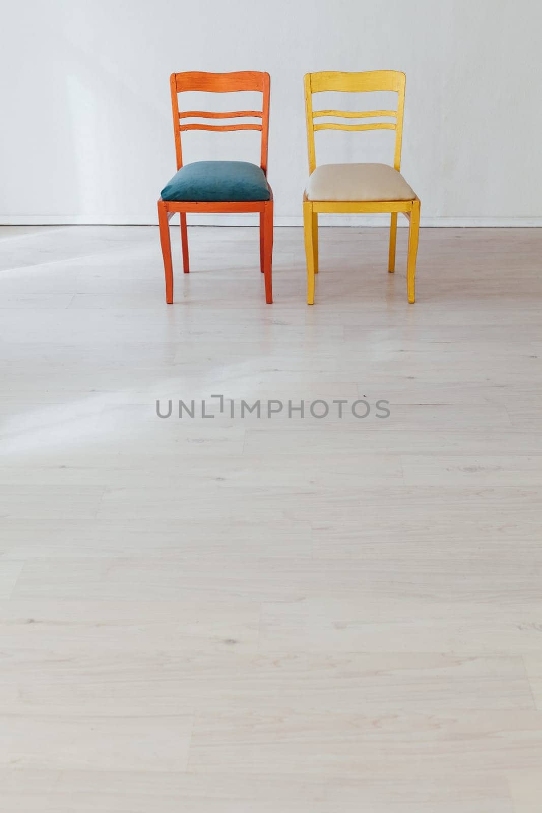 two chairs in the interior of an empty white room by Simakov