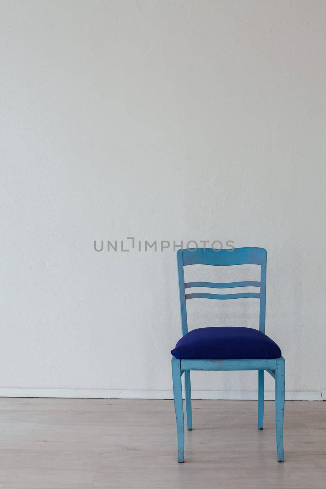 one chair in the interior of an empty white room by Simakov