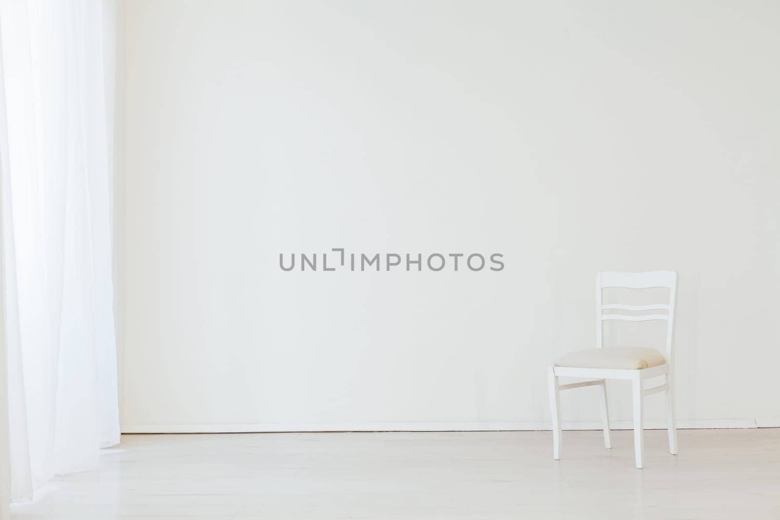 chair in the interior of an empty white room