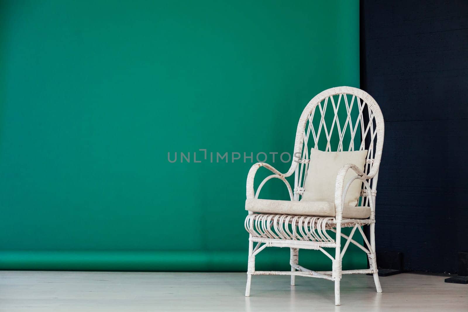 white chair in the interior of the room against a green background by Simakov