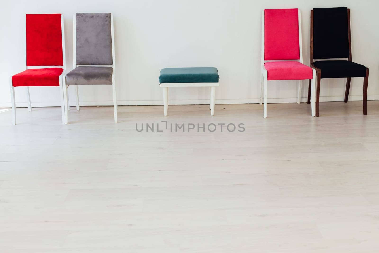 five chairs in an empty white interior room by Simakov