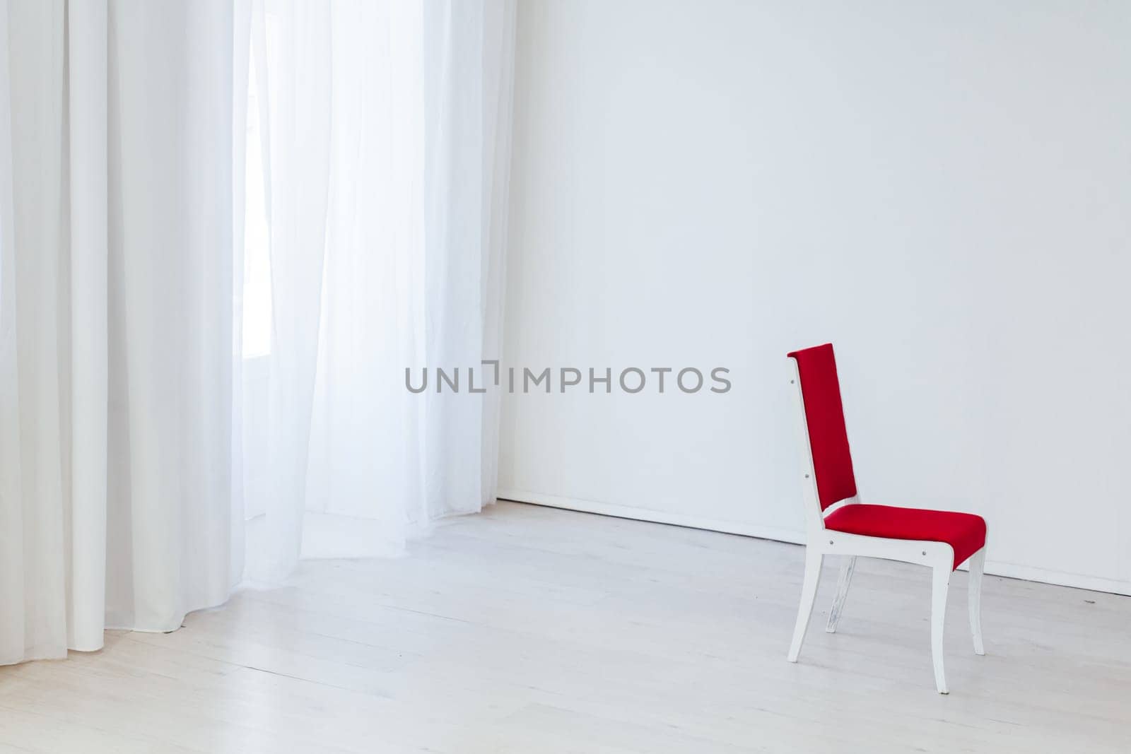 red chair in an empty white interior room by Simakov