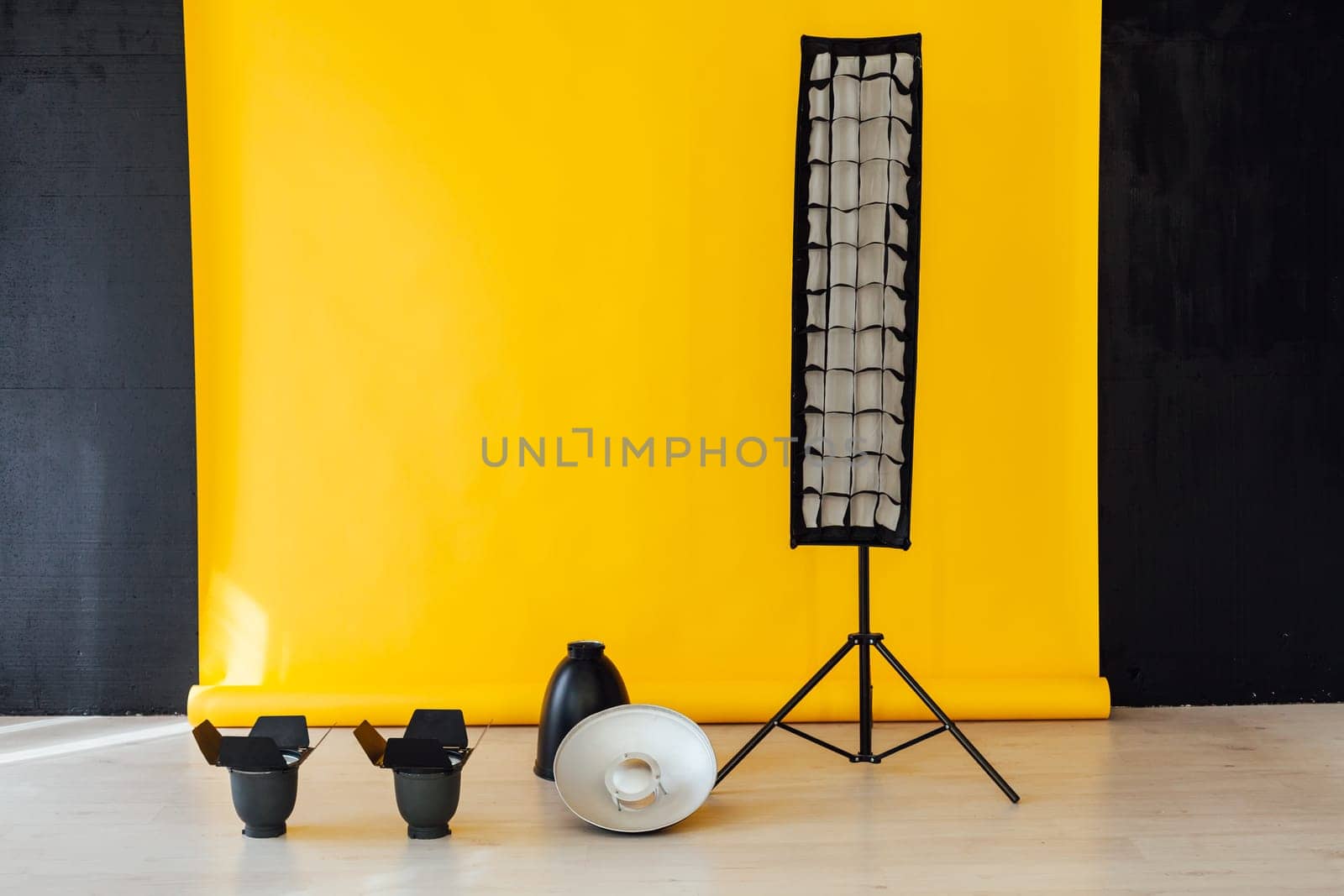 Flash equipment photo studio on yellow with black background by Simakov
