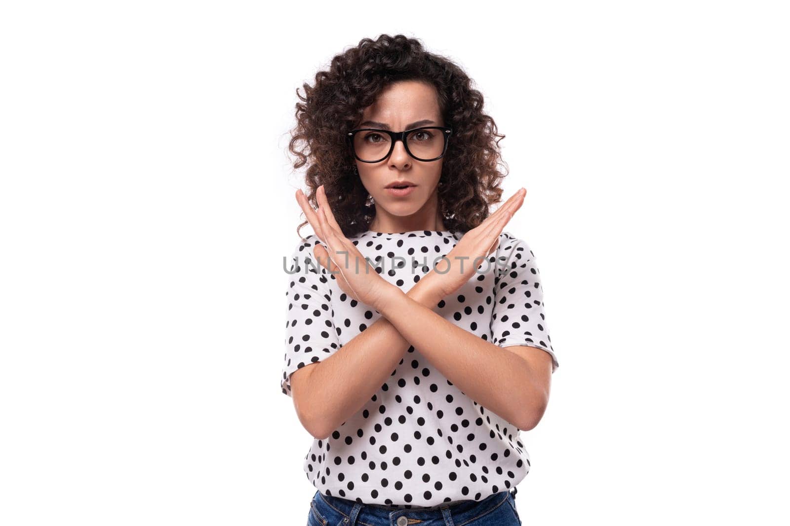 young confident leader woman with curly hairstyle dressed in summer blouse crossed her arms in front of her in disagreement by TRMK