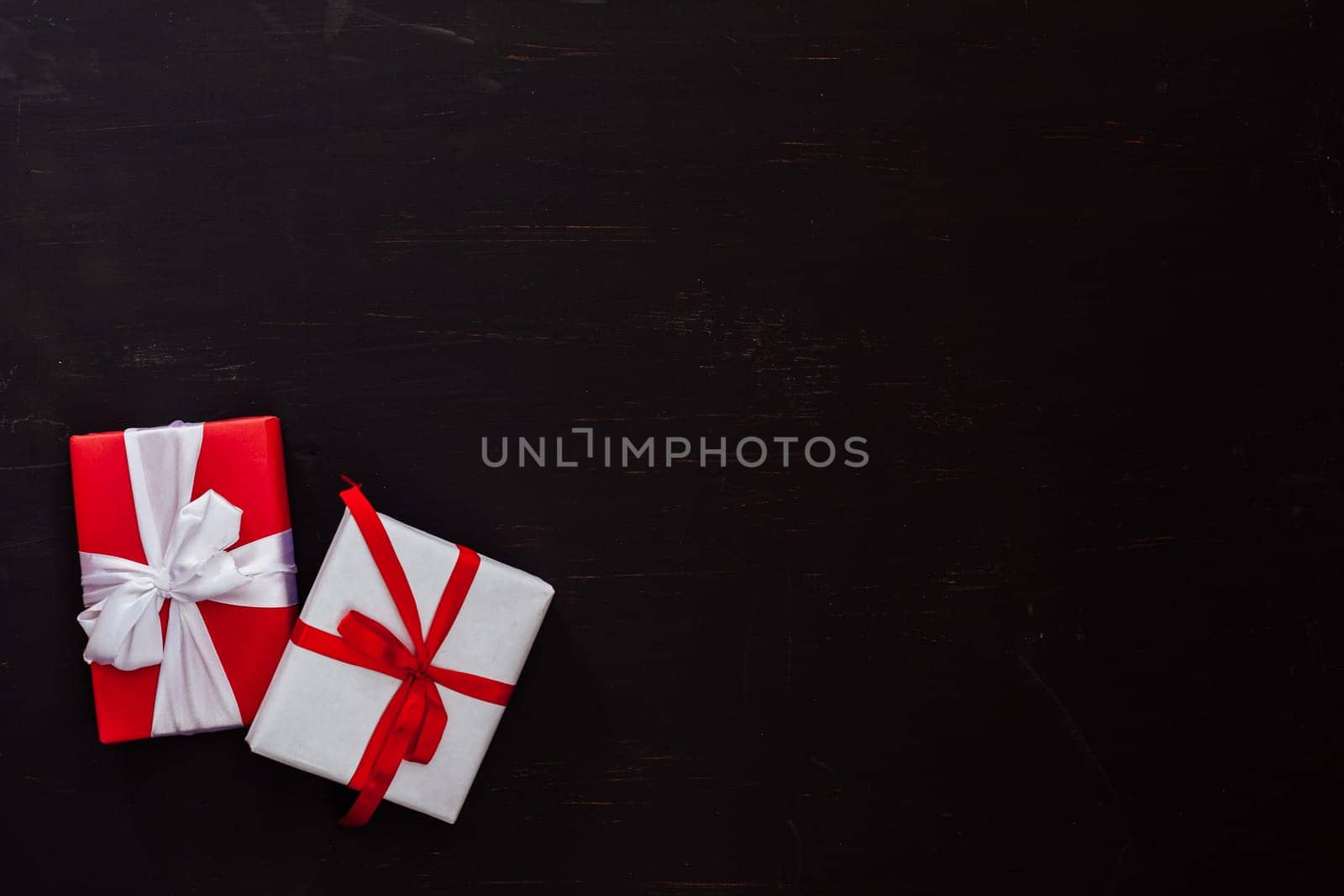two Christmas gifts on a black background by Simakov