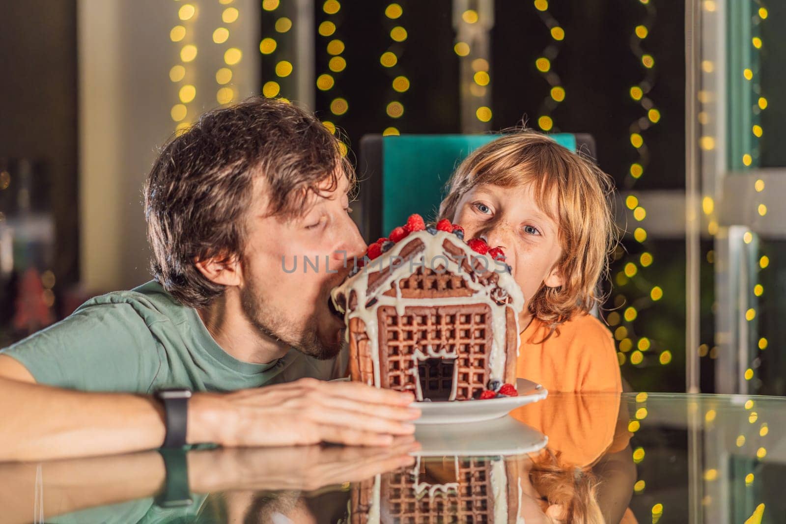 Savor unique moments as dad and son bite into an unconventional gingerbread house, adding a twist to Christmas traditions. A tasty blend of creativity and family joy by galitskaya