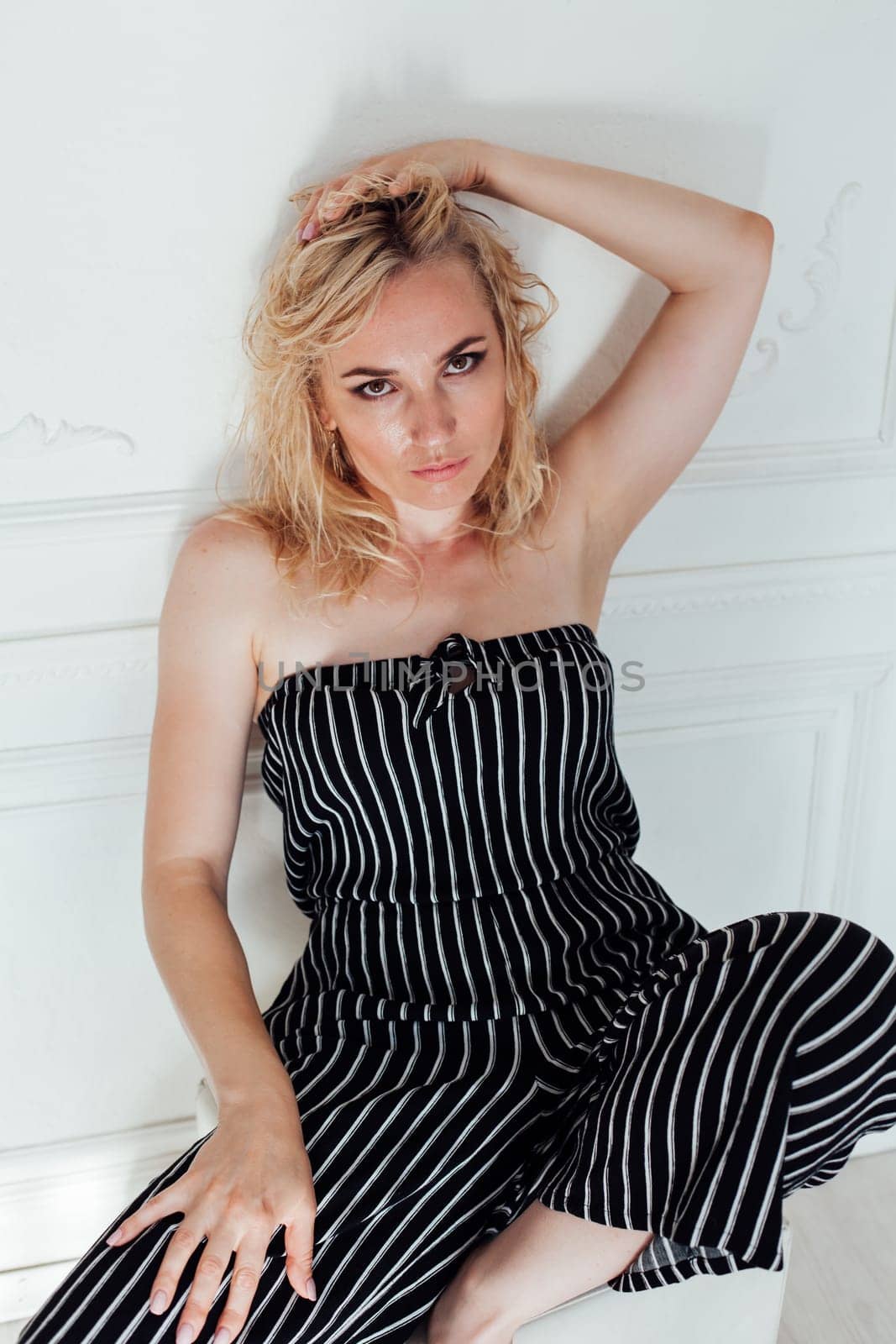 Portrait of a beautiful blonde woman in a striped suit