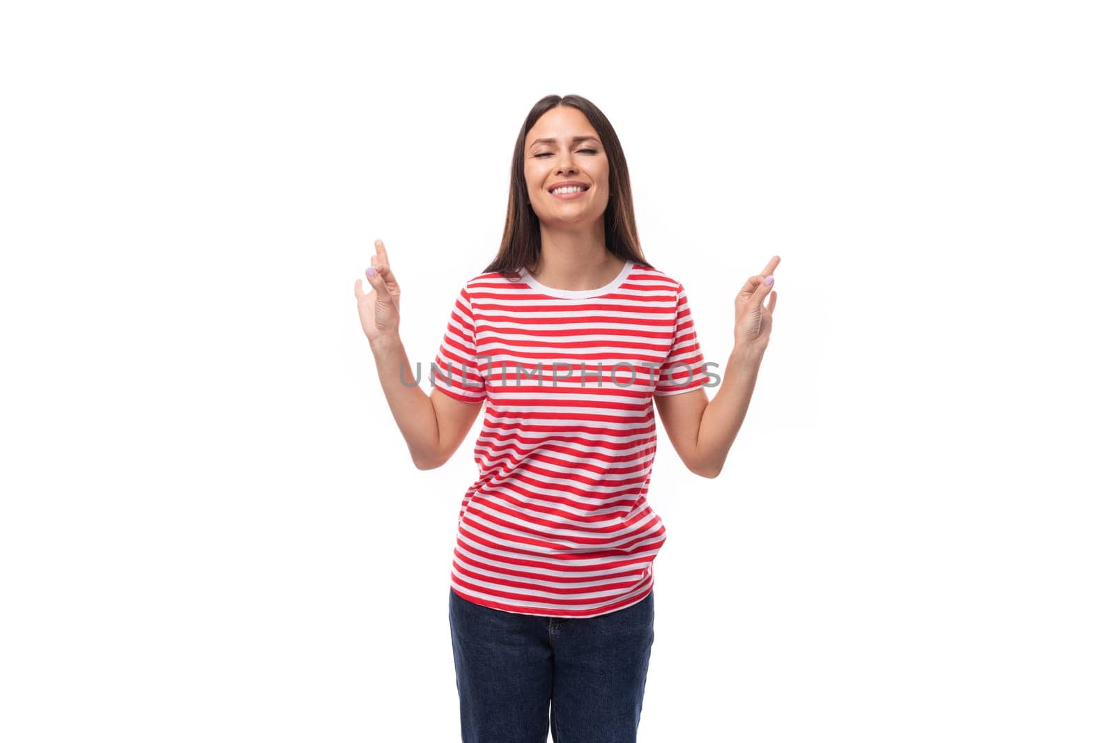 young calm european brunette woman dressed in a striped t-shirt shows that everything is super on a white background by TRMK