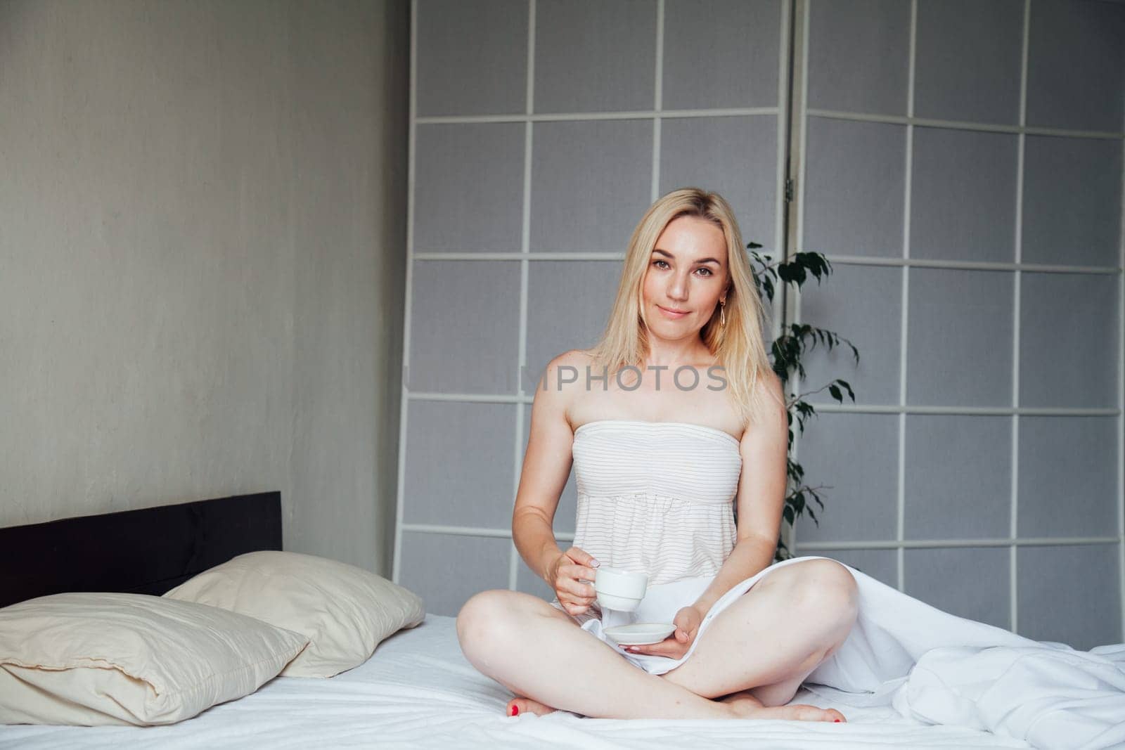 Woman blonde breakfast in the morning on the bed by Simakov