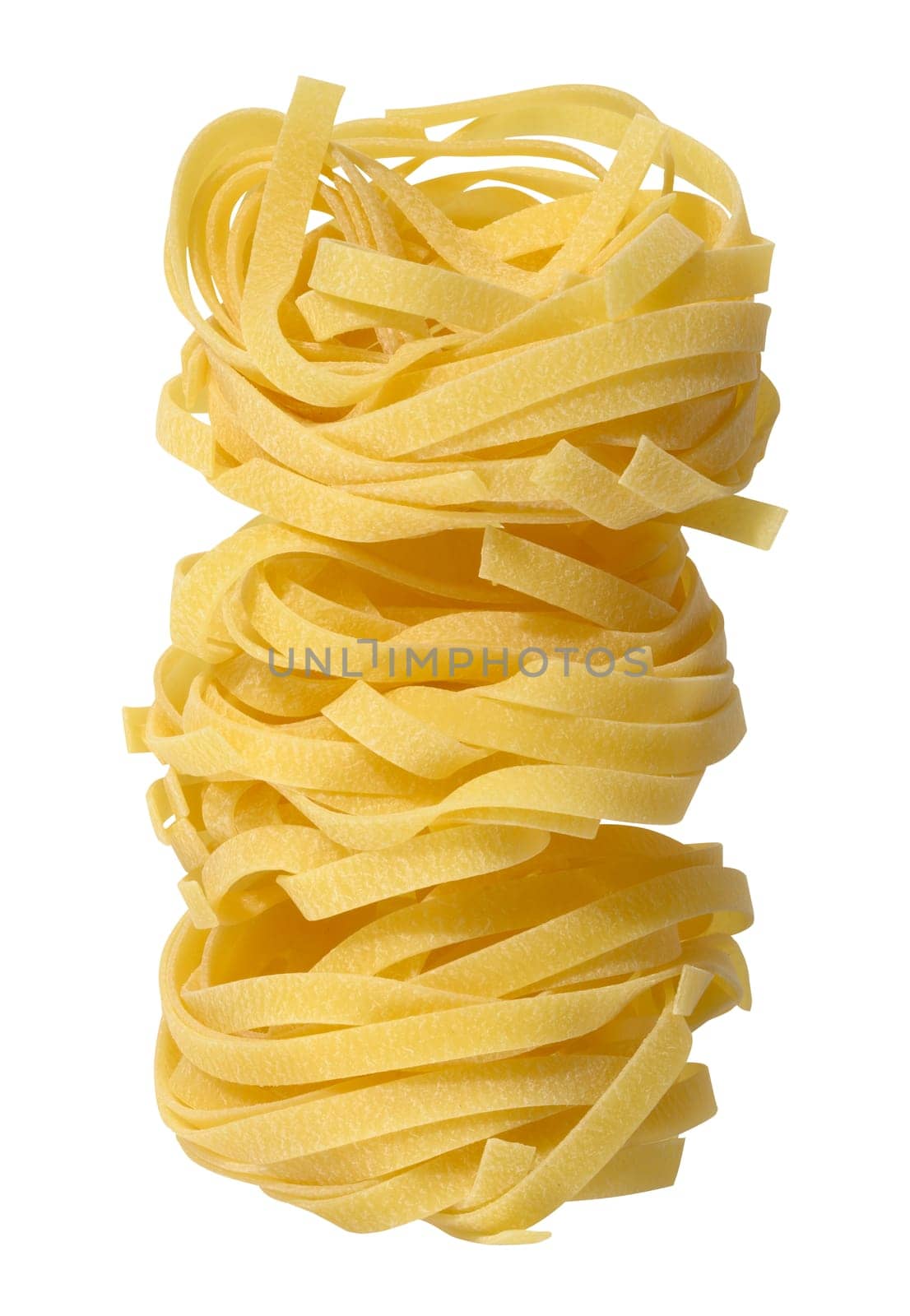 Twisted nest of raw pasta on white background, close up