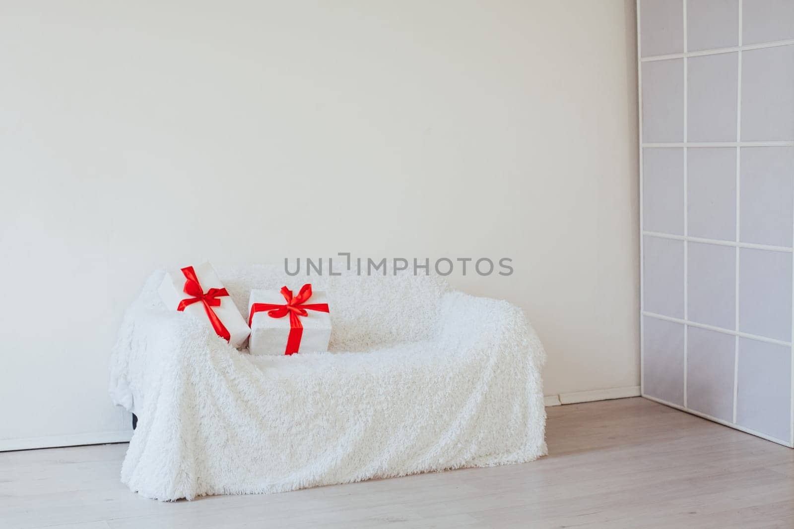 white sofa with gifts in the interior of the room