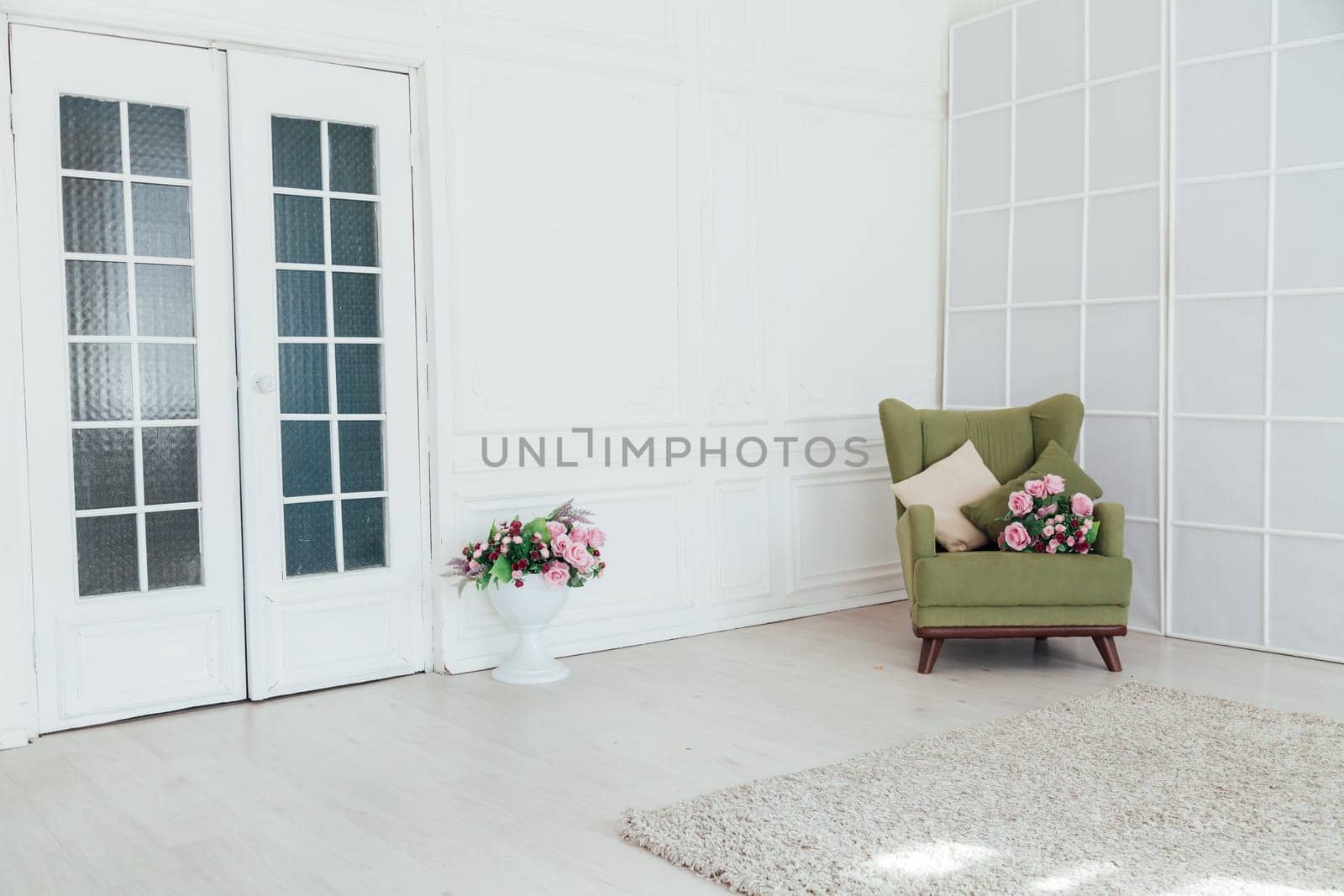 green vintage chair in the interior of an empty white room by Simakov