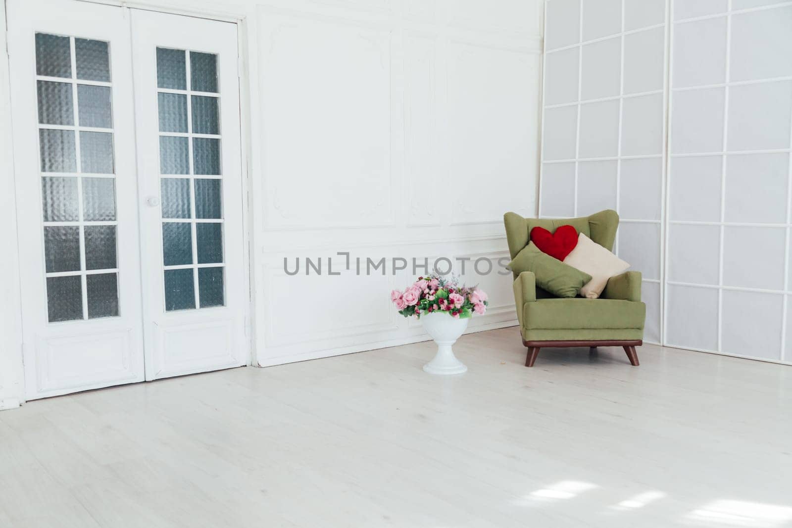 green chair in the interior of an empty white room
